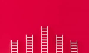 ladders leaning on a red wall