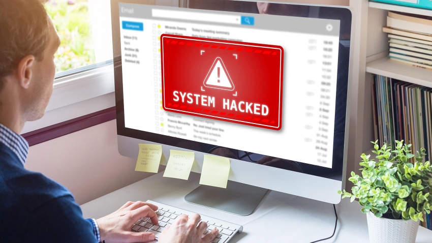 System hacked alert on computer screen after cyber-attack on network.