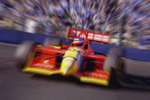 blurred yellow and red racecar presumably driving at a high speed