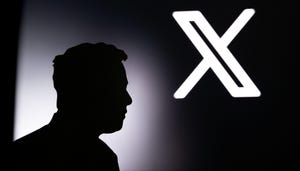 Silhouette of Elon Musk in front of black banner with Twitter new X logo in background.