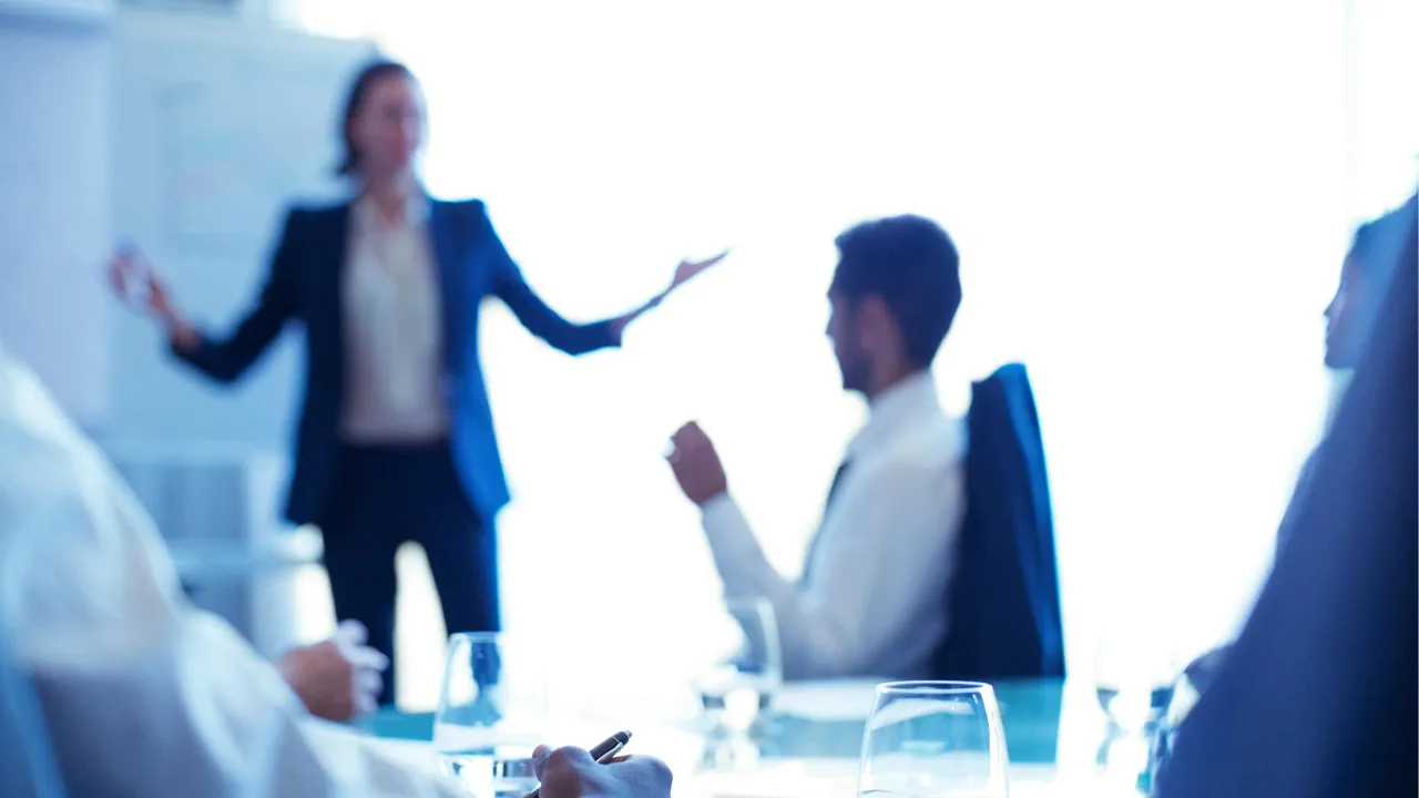 A businesswoman gives a presentation in a boardroom. A businesswoman gives a presentation in a boardroom.