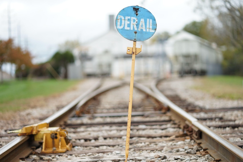 "derail" sign on a railroad