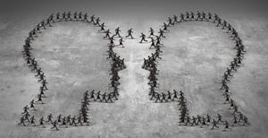 Teamwork leadership business concept or employee poaching symbol as a group of running businesspeople shaped as two heads meeting together.