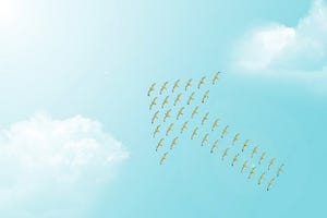 clouds in a turquoise blue sky with birds forming an arrow up