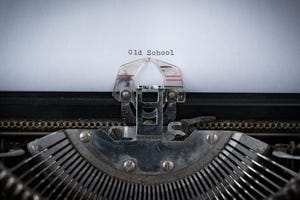 The phrase Old School typed on an old Typewriter