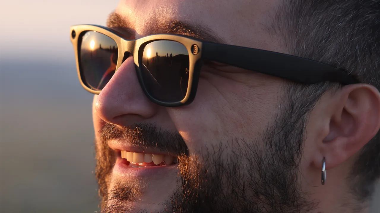 A man smiles while wearing smart glasses A man smiles while wearing smart glasses