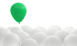 green balloon floating above a bunch of white balloons