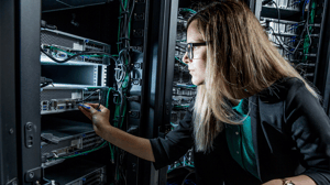 An IT engineer works in a server room An IT engineer works in a server room