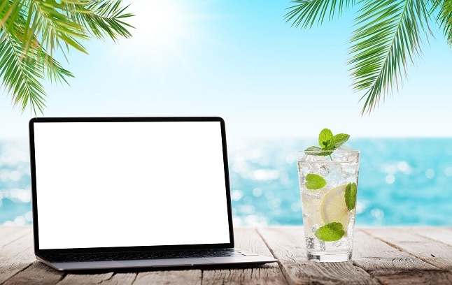 working remotely on a beach with a minty cooling drink