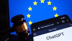 ChatGPT chatbot seen on smartphone, flag of EU on the laptop and gavel on the background