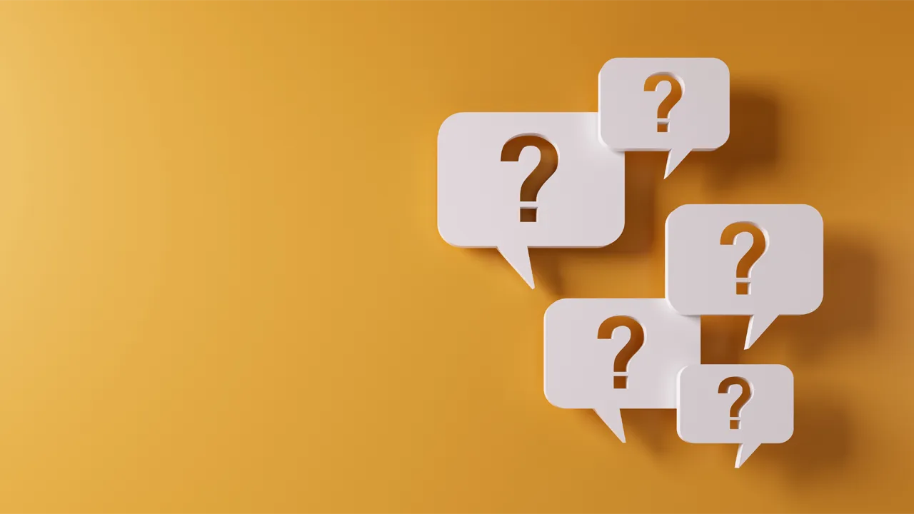 Question mark speech bubbles in front of a yellow wall Question mark speech bubbles in front of a yellow wall