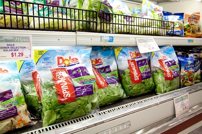 Bagged spinach and lettuce for sale in a grocery store in the USA.