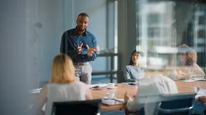 An executive speaks during a meeting in a conference room An executive speaks during a meeting in a conference room