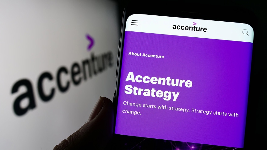 Person holding cellphone with webpage of information technology company Accenture plc on screen with logo. 