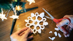 Cutting the snowflake shape out of a paper