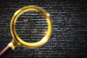 golden magnifying glass looking more closely at code