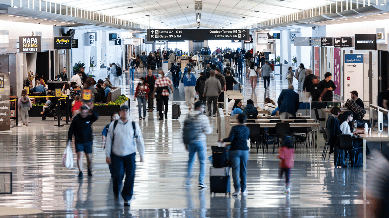 Travelers walk through San Francisco International Airport Travelers walk through San Francisco International Airport