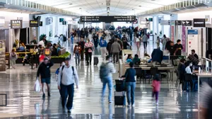 Travelers walk through San Francisco International Airport Travelers walk through San Francisco International Airport