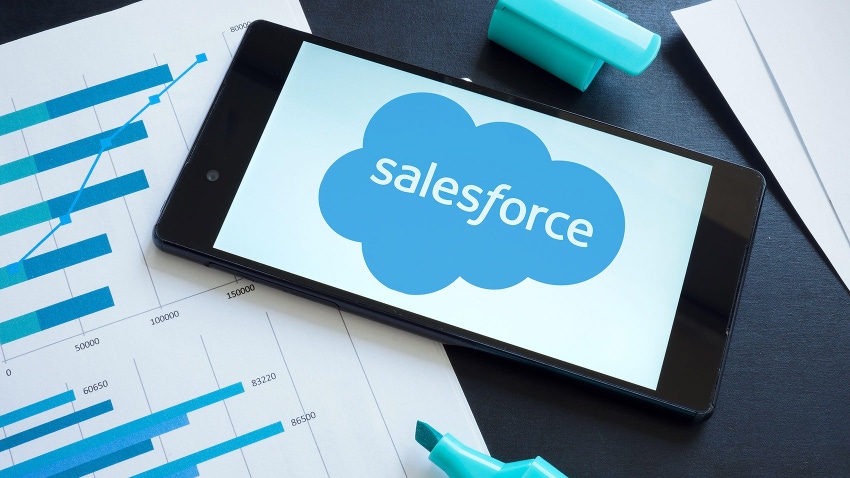Salesforce logo on the smartphone and papers.