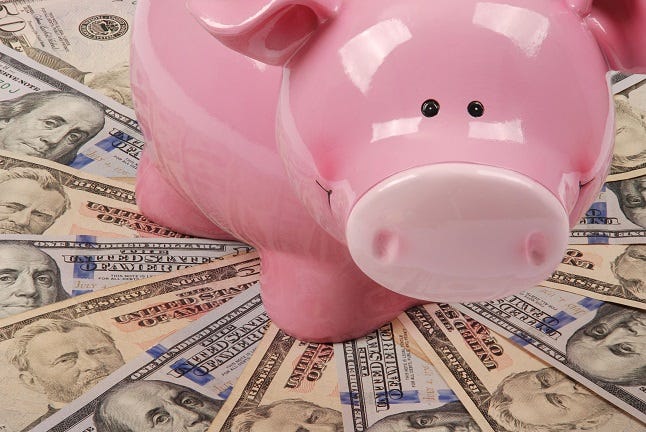 Pink smiling Piggy bank on mandala kaleidoscope from money.