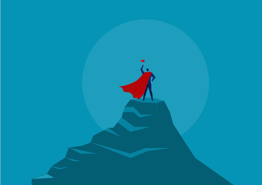 Businessperson Hero holding red flag and standing on the top of the mountain under the sun