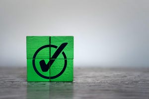 Green wooden cubes with checkmark icon. Corporate regulatory compliance, achievement, completed task