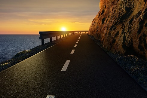 road leading to dangerous cliff with the sun setting