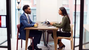 Businesswoman interviewing male job candidate in meeting room Businesswoman interviewing male job candidate in meeting room