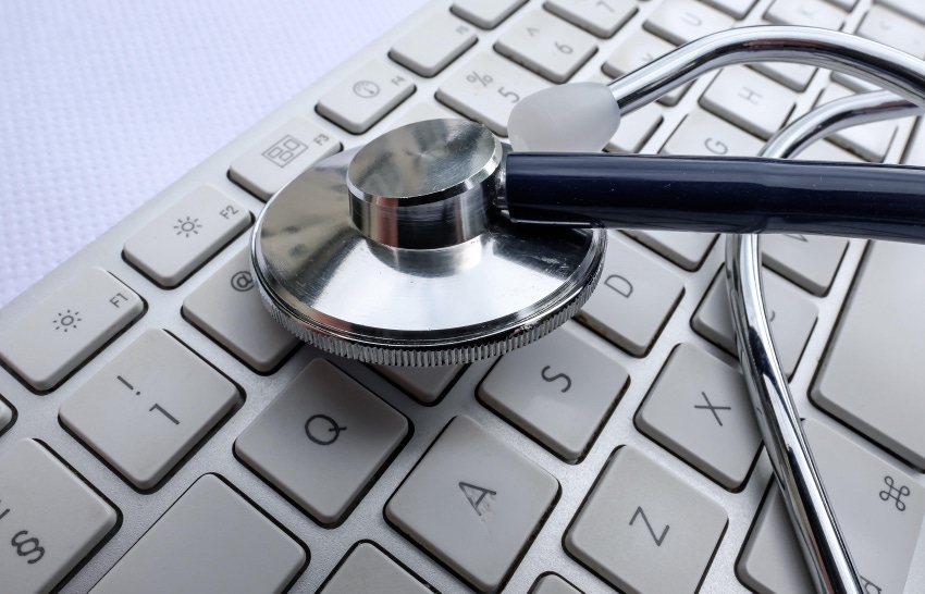 Close-up view of a medical stethoscope seen on a doctors computer keyboard