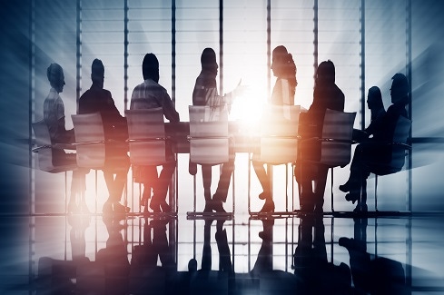 silhouettes of business people sitting in a conference room