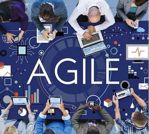 business people working at a table labeled AGILE
