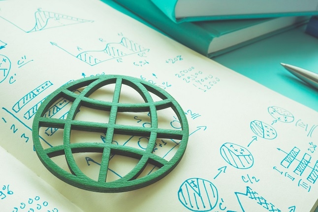 Responsible business concept. Green globe and business notes in a notepad.