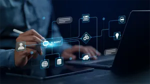 A digital illustration of an AI agent and a workflow is layered over an image of an IT executive holding a stylus. A digital illustration of an AI agent and a workflow is layered over an image of an IT executive holding a stylus.