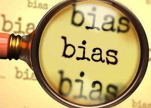 magnifying glass magnifying the word "bias"