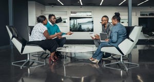 Team of business people sitting in a modern office and talking during an work meeting