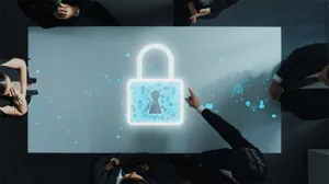 Aerial view of executives sitting around a table, with a digital illustration of a lock in the center of the table Aerial view of executives sitting around a table, with a digital illustration of a lock in the center of the table