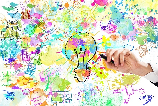 abstract of innovation: drawing on a whiteboard with pastel colors and a lightbulb at center