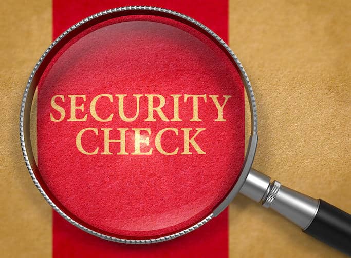 words "security check" in gold letters over red background under a magnifying glass