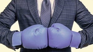 cropped man in suit and boxing gloves ready for corporate business battle