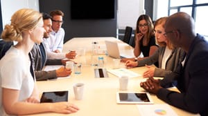Group of young executives holding a work meeting in a conference room Group of young executives holding a work meeting in a conference room