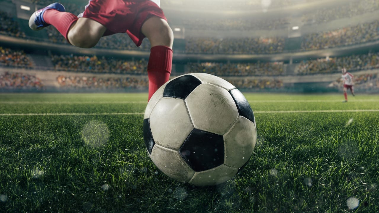 Close-up soccer player with a ball. Soccer players in action in 3D dramatic stadium. Behind the players is a stadium with fans in the stands. Close-up soccer player with a ball. Soccer players in action in 3D dramatic stadium. Behind the players is a stadium with fans in the stands.