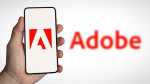 Adobe Logo shown on mobile device and in background.