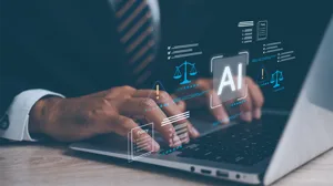 An IT executive works at a laptop with AI icons highlighting responsible technology governance An IT executive works at a laptop with AI icons highlighting responsible technology governance