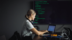 An IT professional types on a laptop An IT professional types on a laptop