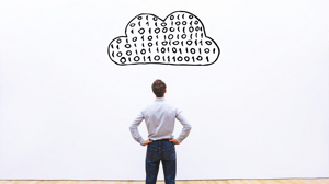 A man looks at a drawing of a cloud with ones and zeros in it A man looks at a drawing of a cloud with ones and zeros in it