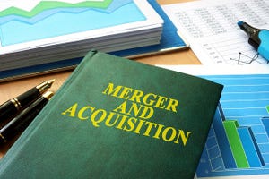 Book on desk with "Merger and Acquistion" title.