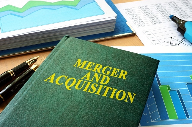 Book on desk with "Merger and Acquistion" title.