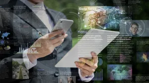 An executive holds a tablet and a smart phone, with an overlay of news illustrations An executive holds a tablet and a smart phone, with an overlay of news illustrations