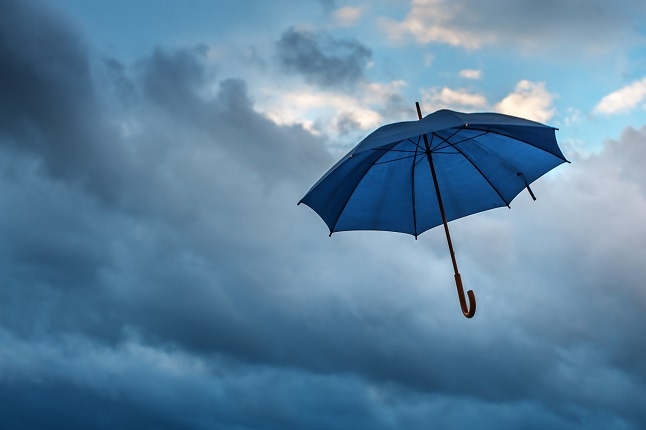 blue umbrella floating up in story sky