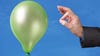 Green balloon about to be burst by a needle held by a businessman's hand in a pinstripe sleeve. Green balloon about to be burst by a needle held by a businessman's hand in a pinstripe sleeve.